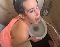 Human toilet girl gets her face untidy with urinate over the toilet