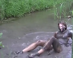 sexy blond girl in mud