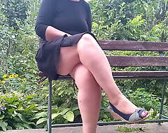 Lecherous MILF pissing while sitting on a bench